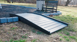 The access ramp is made from poly lumber and weather- resistant. Two ground anchors to secure the ramp to the ground. Color of ramp matches deck color of playground.