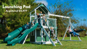 The Launching Pad swing set is another set that can easily grow with your family. It’s equipped with a clubhouse, two slides, full-width rock wall, a staircase, and a 10’ high swing beam. It has a tube slide & 10ft avalanche slide for the big kids & tic-tac-toe, telescope and ship’s wheel for the littles. Choose white swing set with gray decking or ivory swing set with brown decking. Recommended ages 2-14 years old. Price as pictured $13,977.00 - not including delivery and installation.